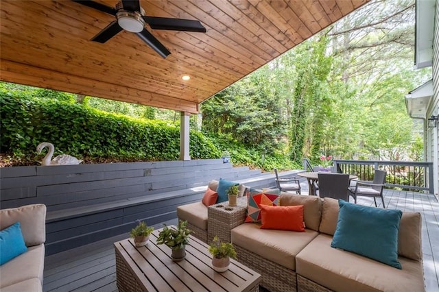 wooden terrace featuring outdoor dining area, an outdoor hangout area, and ceiling fan