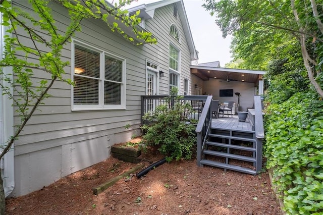 view of property exterior featuring a deck and a ceiling fan