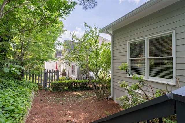 view of side of home with fence