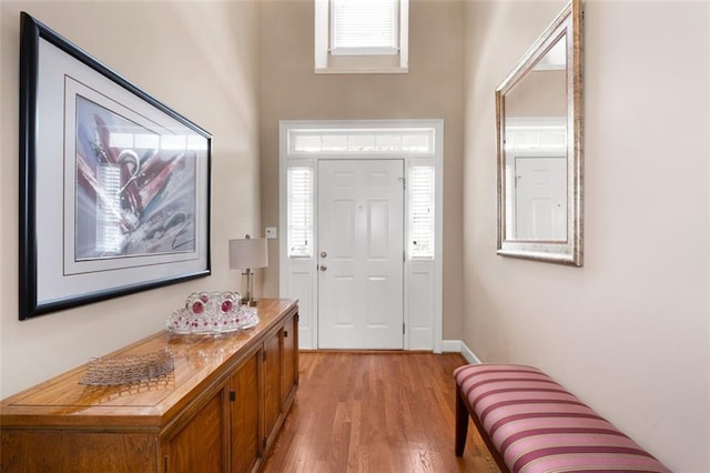 entrance foyer featuring light wood-style flooring and baseboards