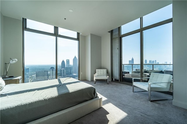 carpeted bedroom with a wall of windows