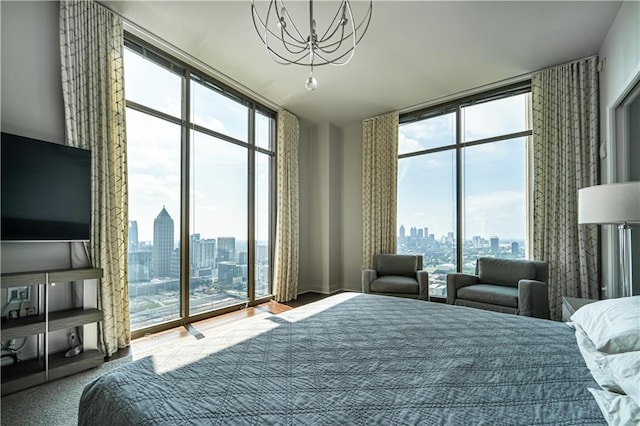 bedroom with floor to ceiling windows, access to outside, and a chandelier