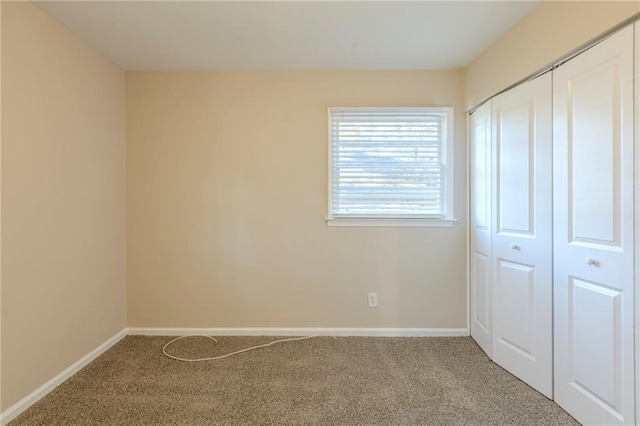 unfurnished bedroom with carpet floors and a closet