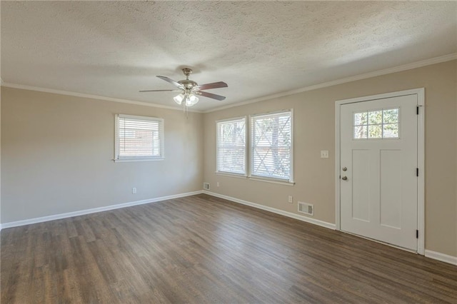 foyer entrance featuring a wealth of natural light, dark hardwood / wood-style floors, and ornamental molding