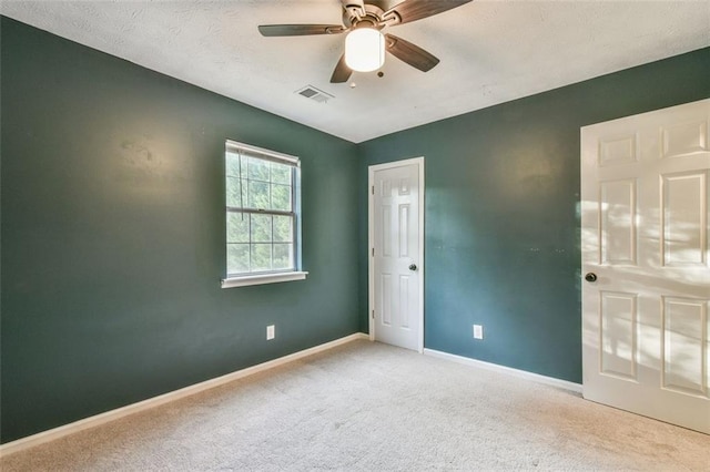 unfurnished bedroom with visible vents, baseboards, a ceiling fan, and carpet floors