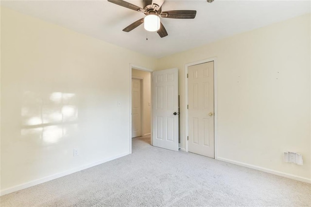 unfurnished bedroom featuring ceiling fan, baseboards, and carpet