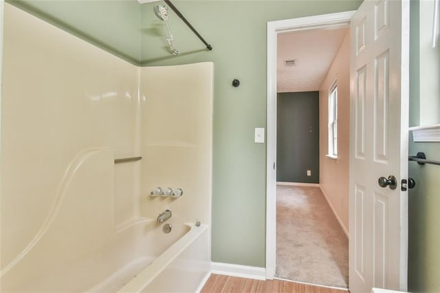full bath featuring wood finished floors, visible vents, baseboards, and shower / bathtub combination