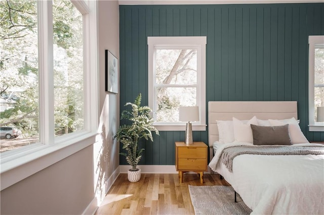 bedroom featuring wood finished floors and baseboards