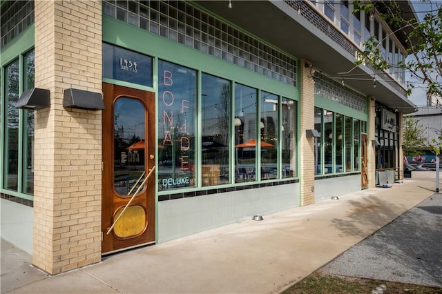 doorway to property with brick siding