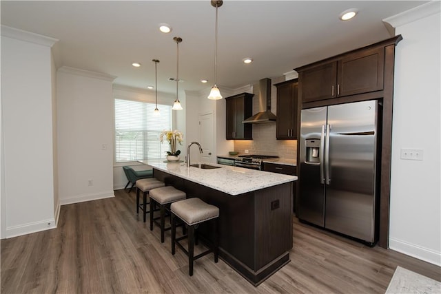3195 Bartee Walk, Suwanee, GA 30024 - kitchen with stainless steel appliances, wall chimney range hood, a sink, dark brown cabinetry, and baseboards