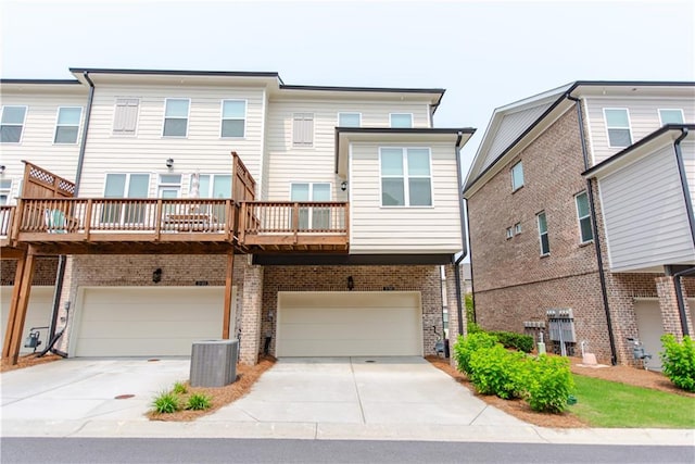 3195 Bartee Walk, Suwanee, GA 30024 - back of house featuring an attached garage, driveway, central AC unit, and brick siding