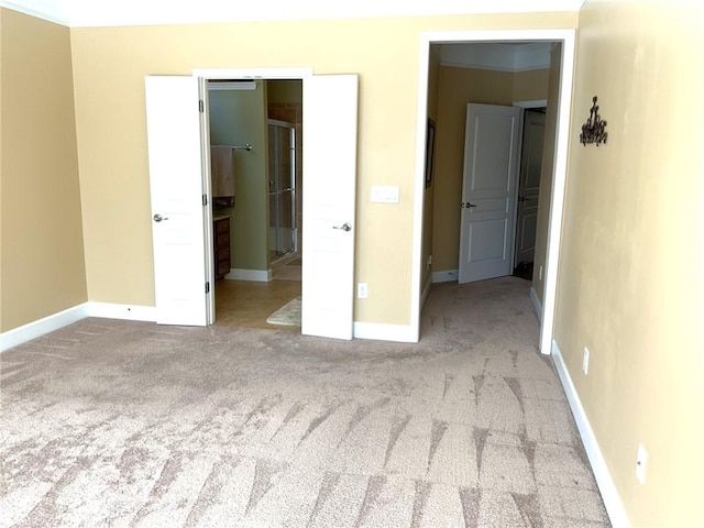 unfurnished bedroom with a spacious closet, baseboards, and carpet flooring