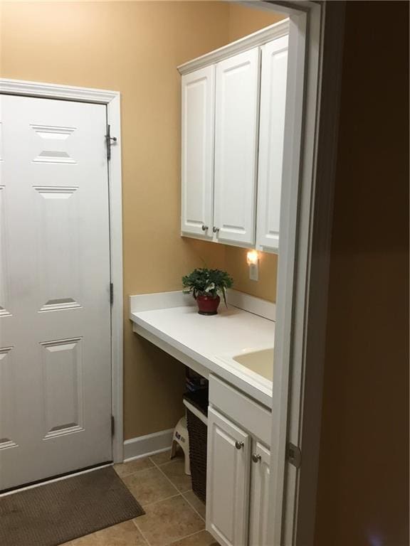 interior space with tile patterned flooring, vanity, and baseboards