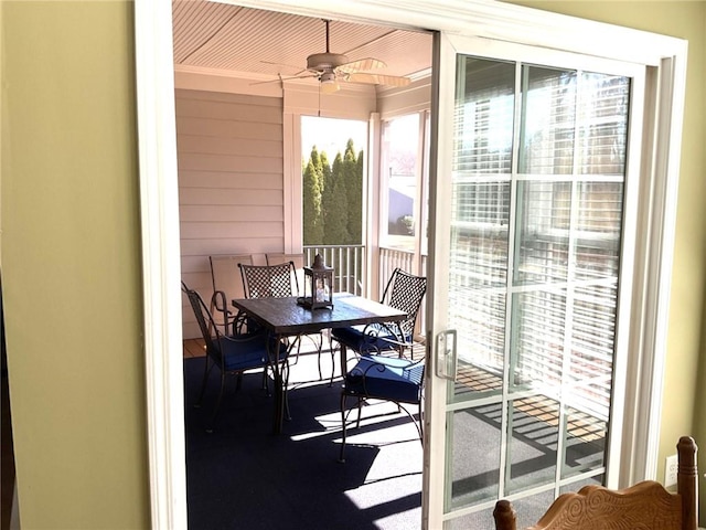 sunroom / solarium with a ceiling fan