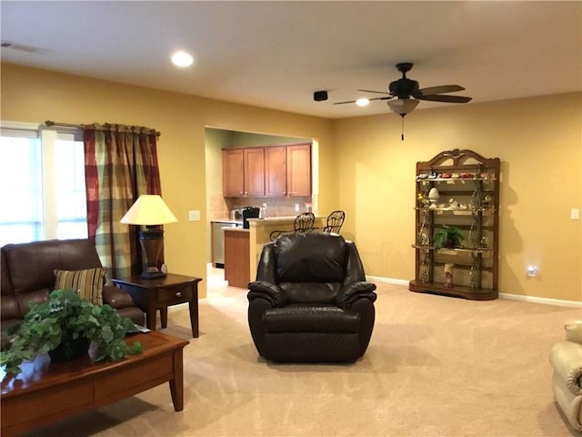 living area featuring recessed lighting, baseboards, ceiling fan, and light colored carpet