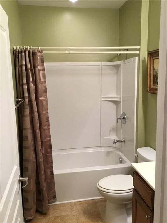 full bath featuring toilet, vanity, shower / bath combo with shower curtain, and tile patterned floors