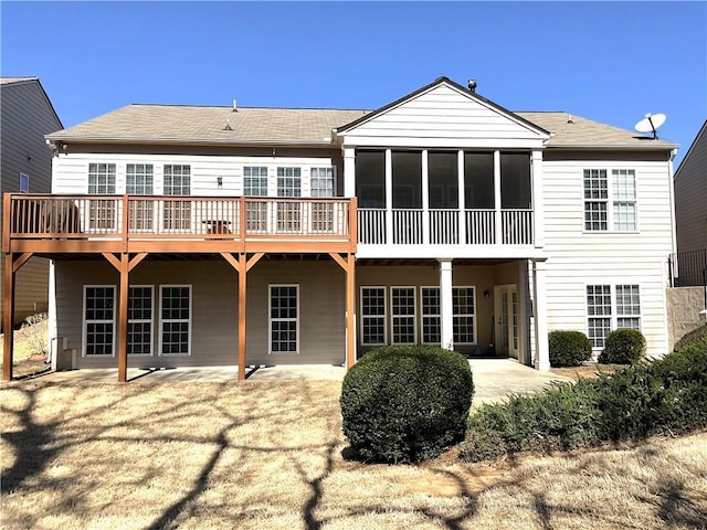 rear view of house featuring a patio area and a sunroom