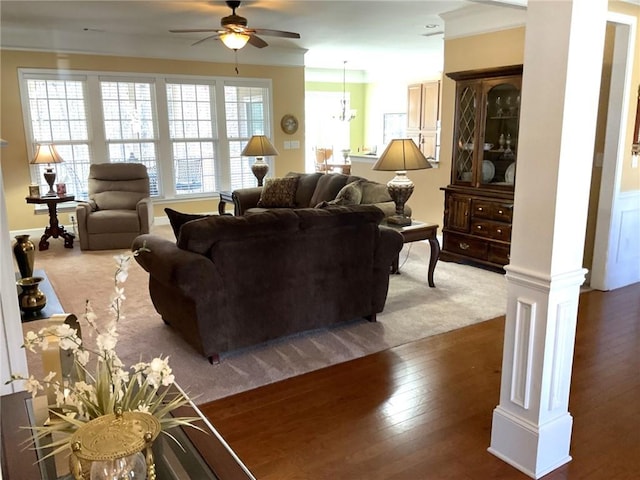 living area with wood-type flooring, ceiling fan, and decorative columns