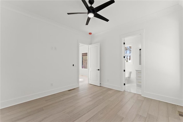 interior space with crown molding, ceiling fan, and light wood-type flooring