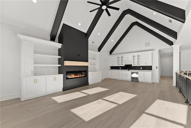 unfurnished living room featuring ornate columns, high vaulted ceiling, beverage cooler, ceiling fan, and beam ceiling