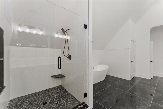 bathroom featuring lofted ceiling and independent shower and bath