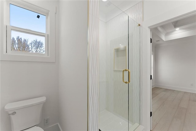 bathroom with a shower with door, hardwood / wood-style floors, and toilet