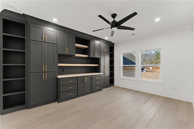 unfurnished living room featuring ceiling fan and light wood-type flooring