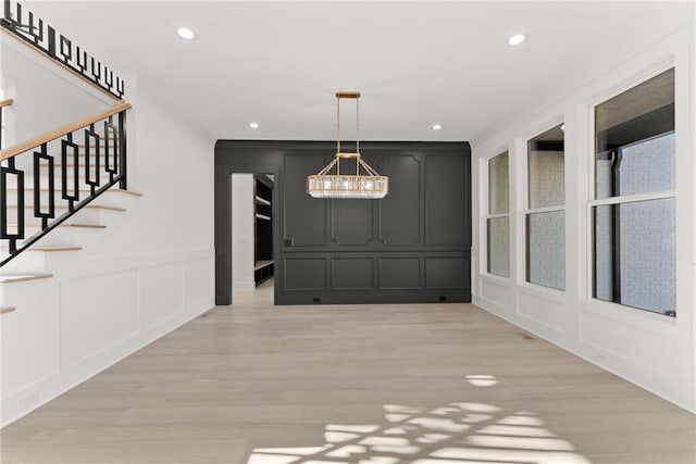 interior space featuring a chandelier and light hardwood / wood-style floors