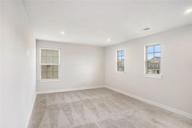 spare room with light colored carpet