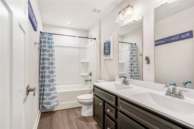 full bathroom with shower / bath combination with curtain, vanity, toilet, and hardwood / wood-style floors