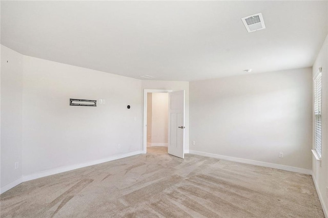 unfurnished room featuring light colored carpet