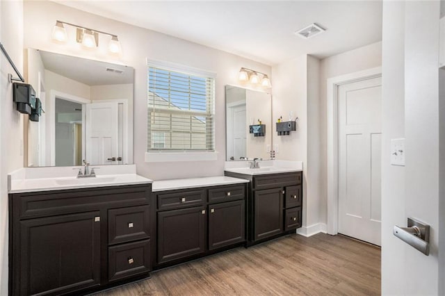 bathroom with hardwood / wood-style floors and vanity