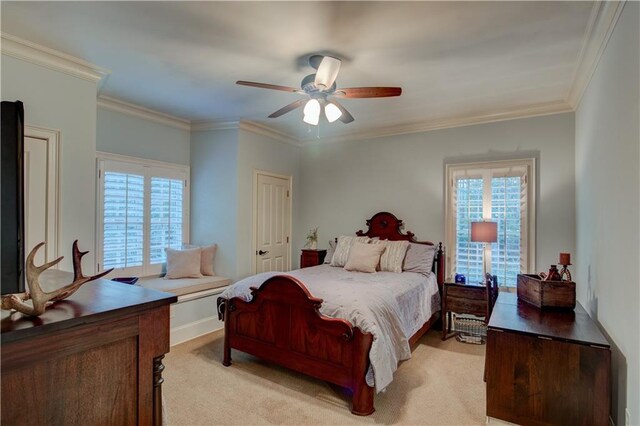 carpeted bedroom with ceiling fan and crown molding