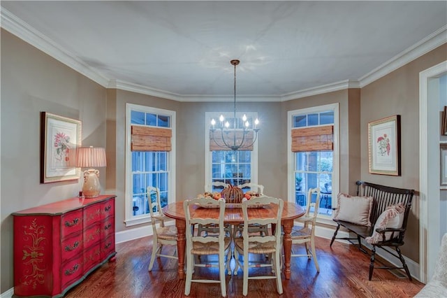 dining space with crown molding, dark hardwood / wood-style floors, and a notable chandelier