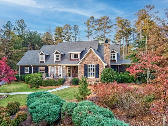 new england style home featuring a front yard