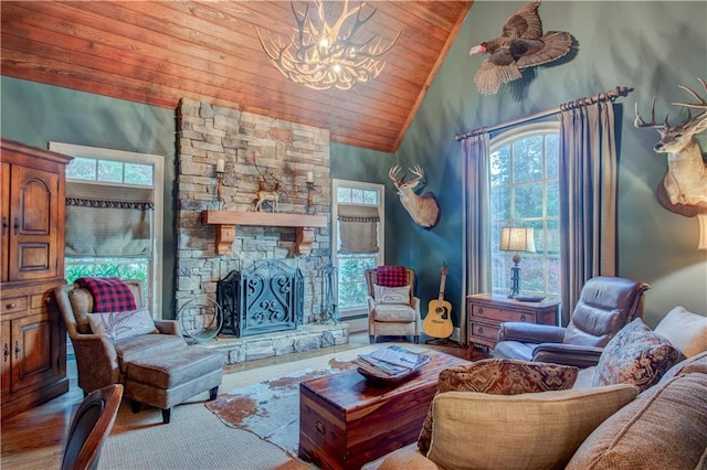 living room with high vaulted ceiling, a stone fireplace, a notable chandelier, and wood ceiling