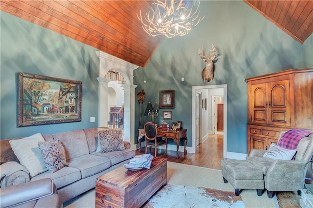 living room featuring light hardwood / wood-style floors, wood ceiling, high vaulted ceiling, and a chandelier