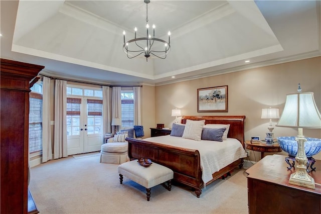 bedroom featuring access to exterior, french doors, light carpet, and a tray ceiling