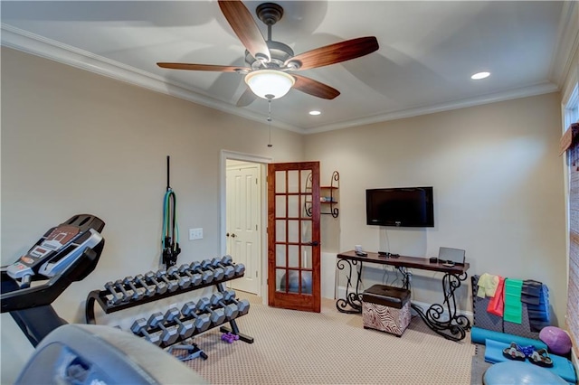 exercise area featuring ceiling fan, carpet, and ornamental molding