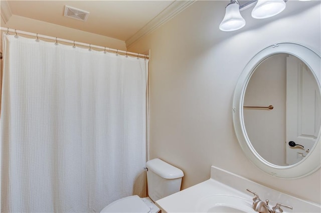 bathroom with toilet, ornamental molding, and sink