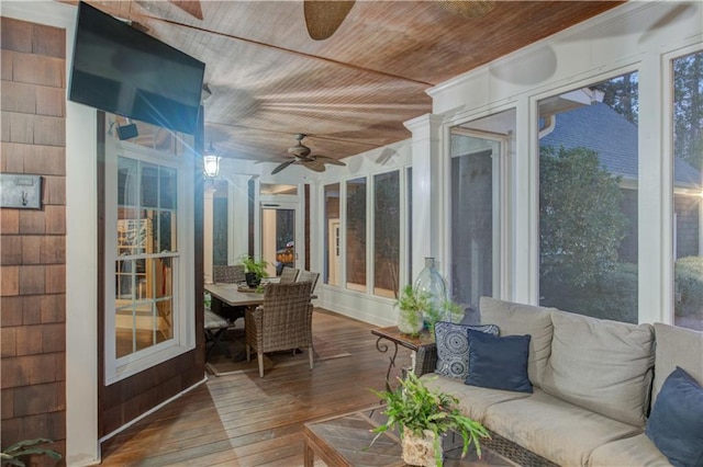 sunroom with ceiling fan and wooden ceiling