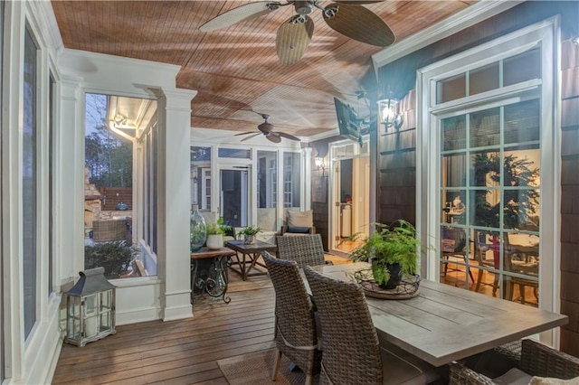 sunroom / solarium featuring ornate columns, ceiling fan, and wood ceiling