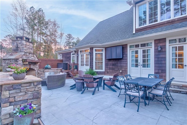 view of patio / terrace with an outdoor living space with a fireplace