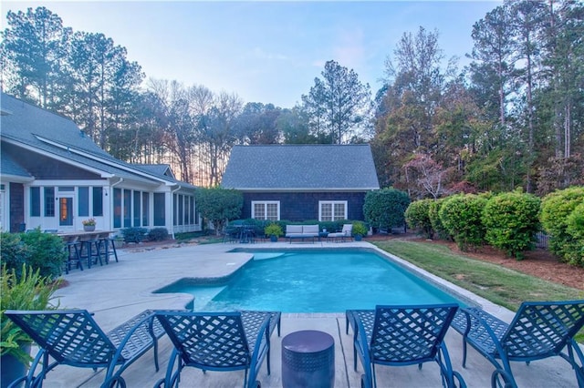 view of pool featuring an outdoor bar and a patio