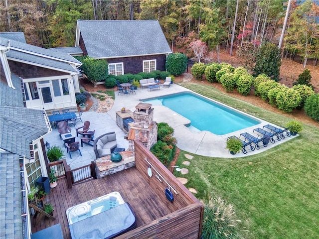 view of pool featuring a yard, an outdoor living space with a fire pit, and a deck