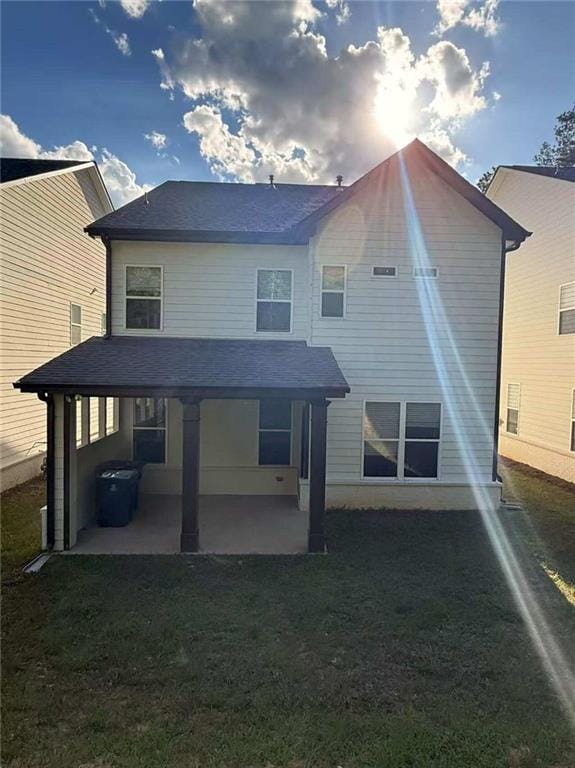 1923 Westfall Lndg, Auburn, GA 30011 - rear view of property featuring a patio area, a lawn, and roof with shingles