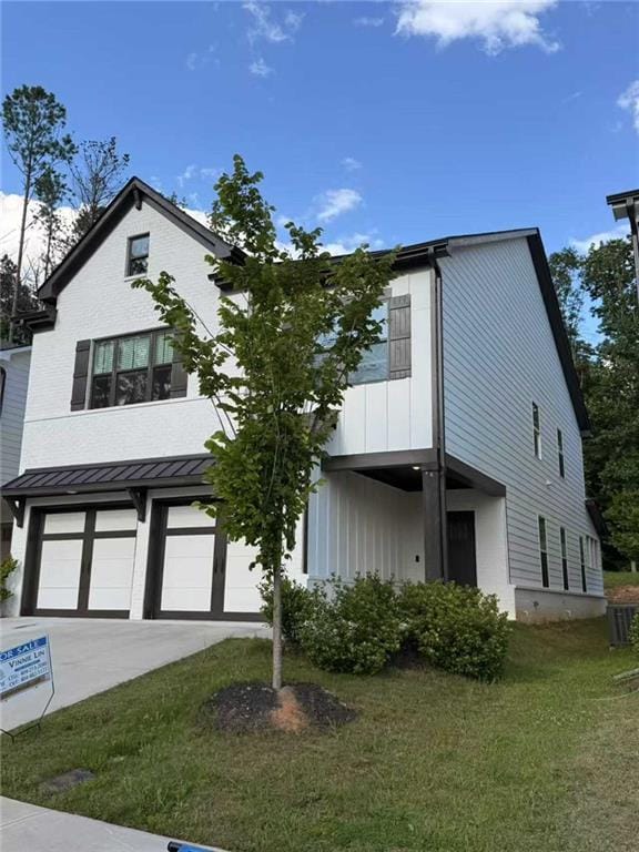 1923 Westfall Lndg, Auburn, GA 30011 - view of front of property featuring an attached garage, a front yard, concrete driveway, a standing seam roof, and a metal roof