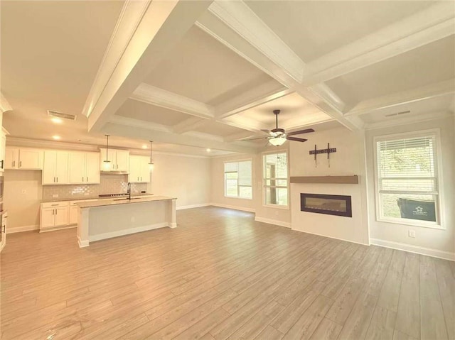 1923 Westfall Lndg, Auburn, GA 30011 - unfurnished living room with light wood-style floors, a ceiling fan, beamed ceiling, a glass covered fireplace, and coffered ceiling