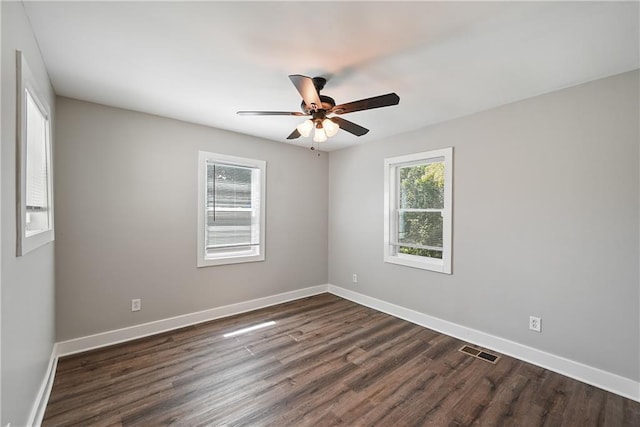 spare room featuring ceiling fan and dark wood-type flooring