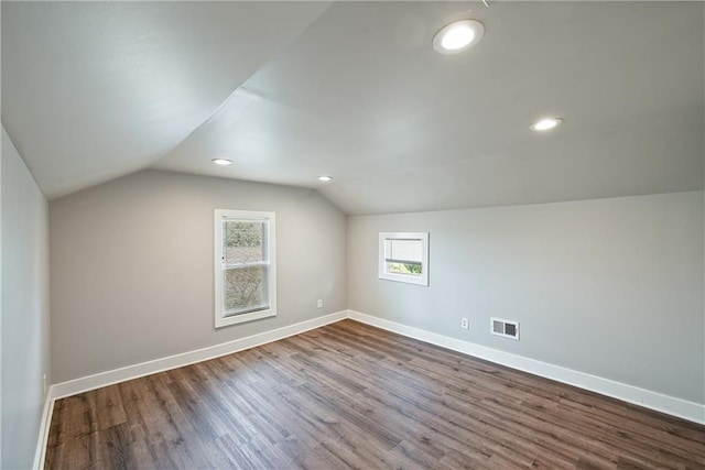 bonus room with lofted ceiling and hardwood / wood-style floors